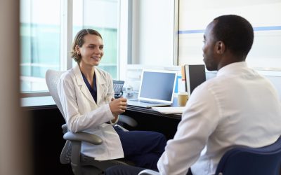 Doctor In Consultation With Male Patient In Office